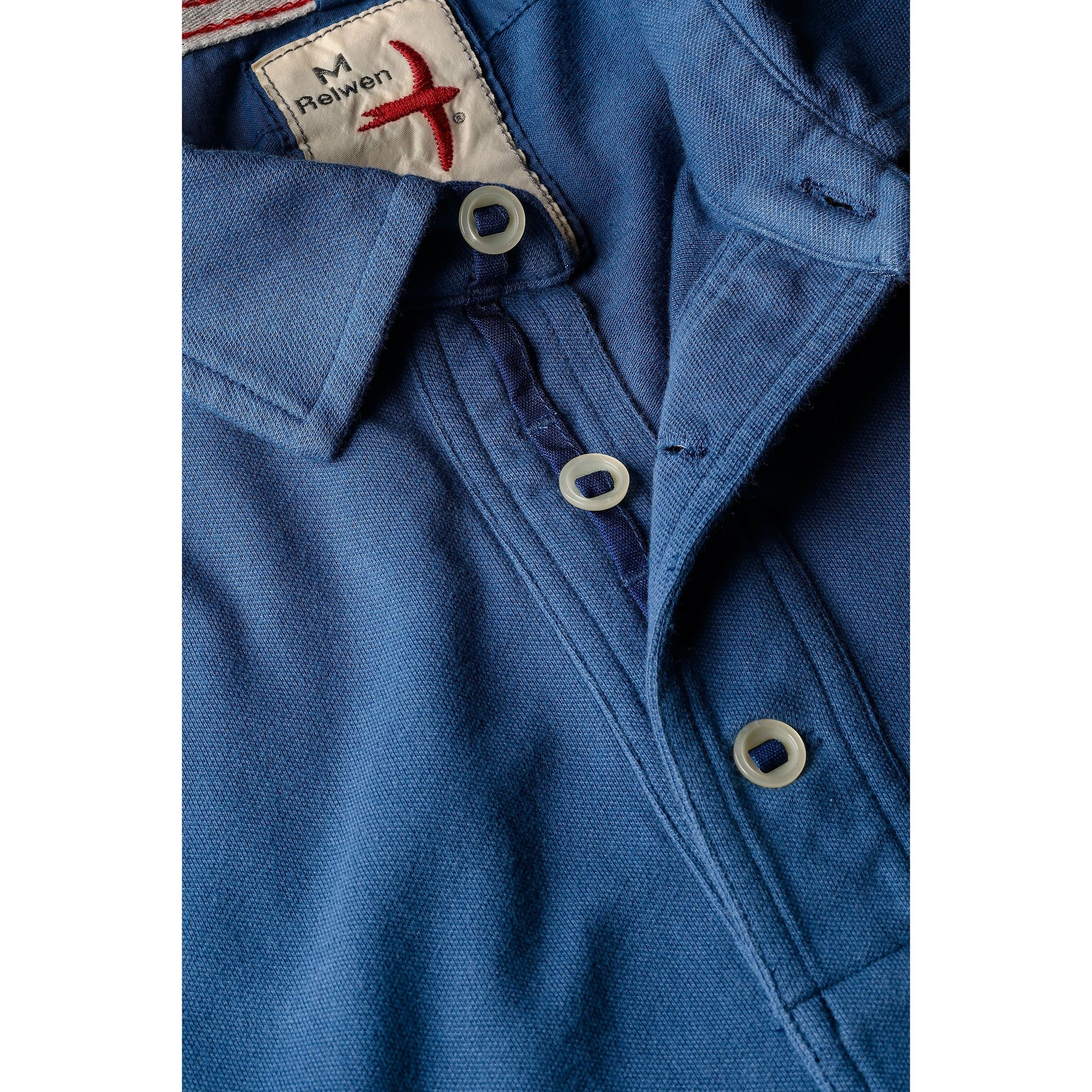 Men's marine blue pique slot polo shirt by Relwen, featuring a classic fit and textured fabric, shown on a model.