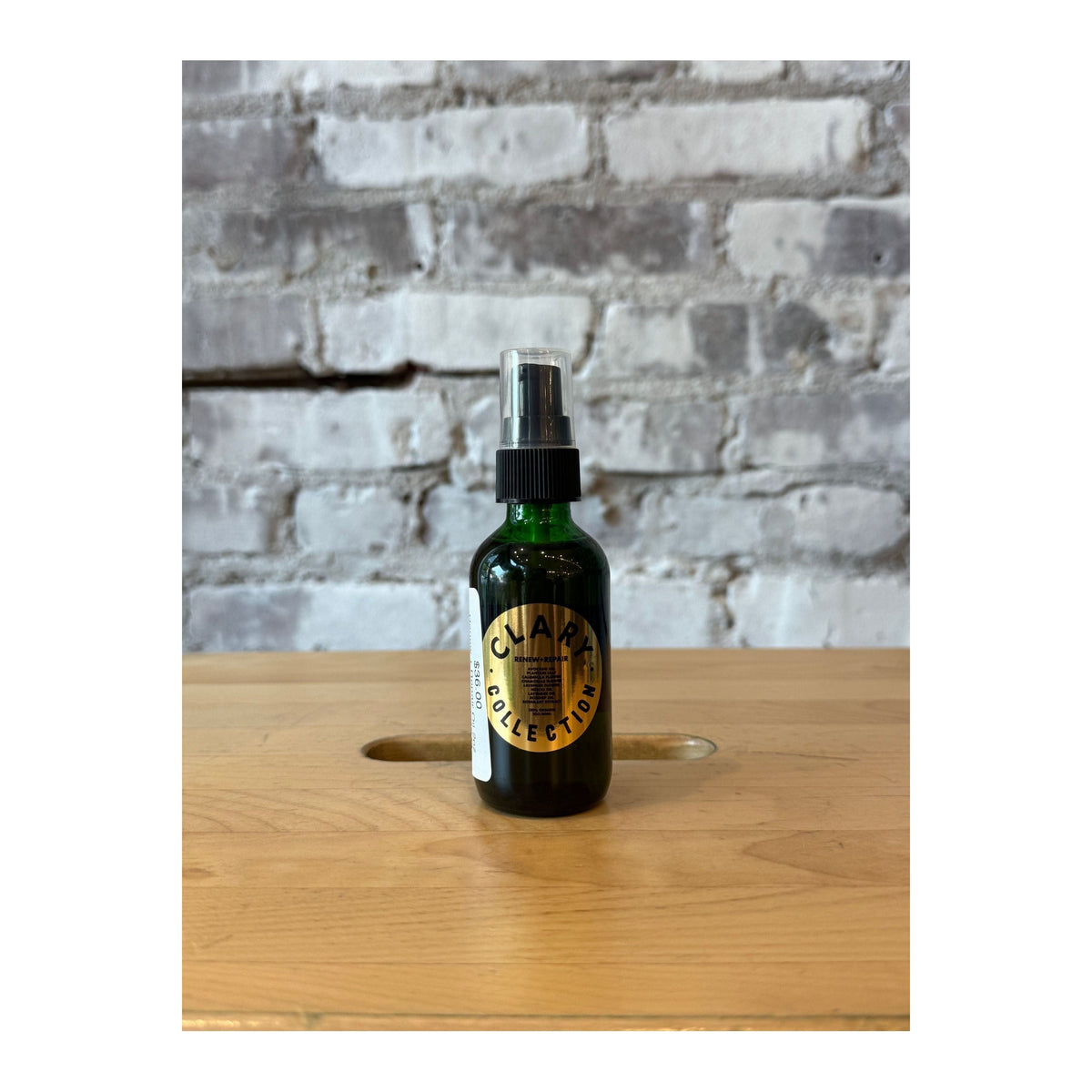 Clary Collection Renew + Repair Oil 2oz in a small glass bottle with dropper, designed for hair or skincare benefits.
