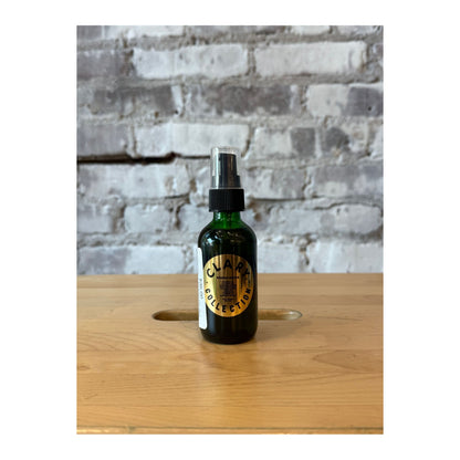 Clary Collection Renew + Repair Oil 2oz in a small glass bottle with dropper, designed for hair or skincare benefits.