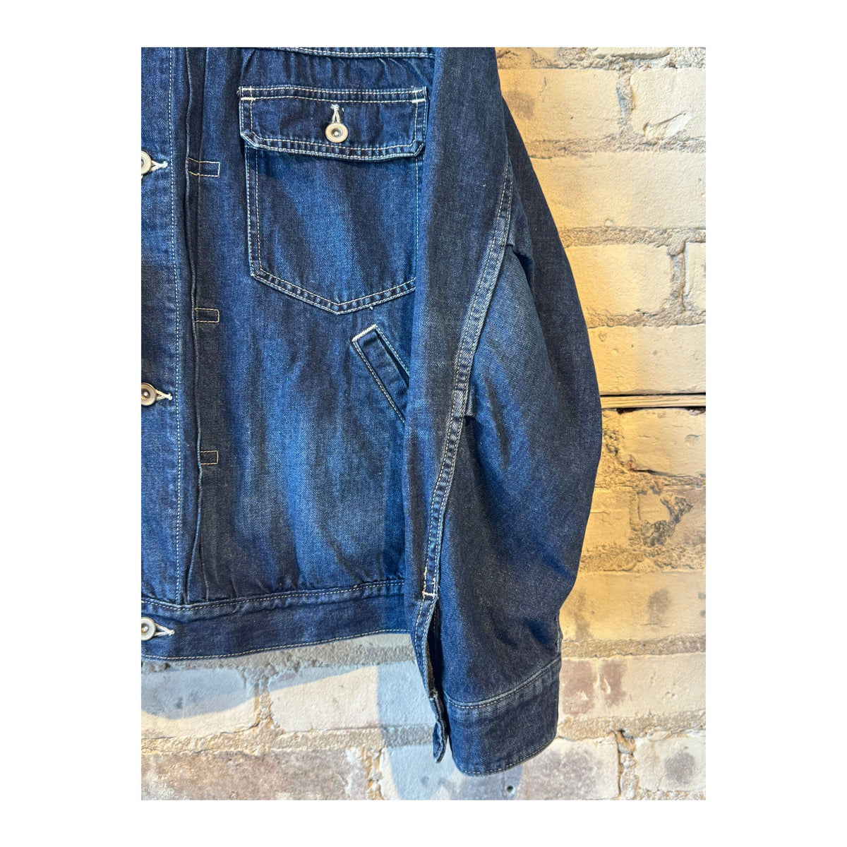 Men's indigo blue denim short jacket by Sage De Cret, featuring a casual fit and classic denim styling.