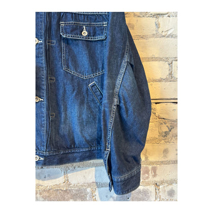Men's indigo blue denim short jacket by Sage De Cret, featuring a casual fit and classic denim styling.