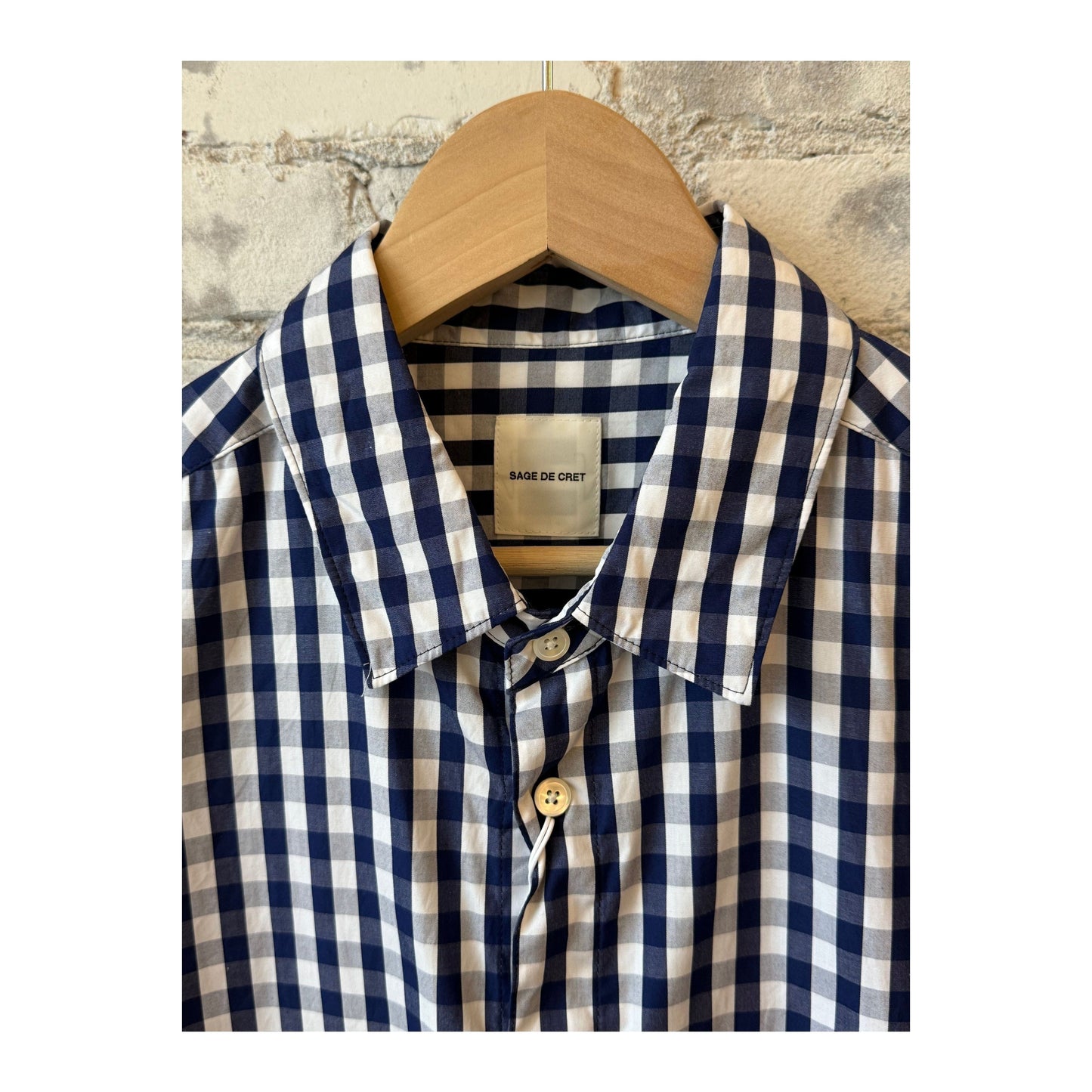 Men's navy gingham check shirt with regular collar by Sage De Cret, showing the classic pattern and tailored fit.