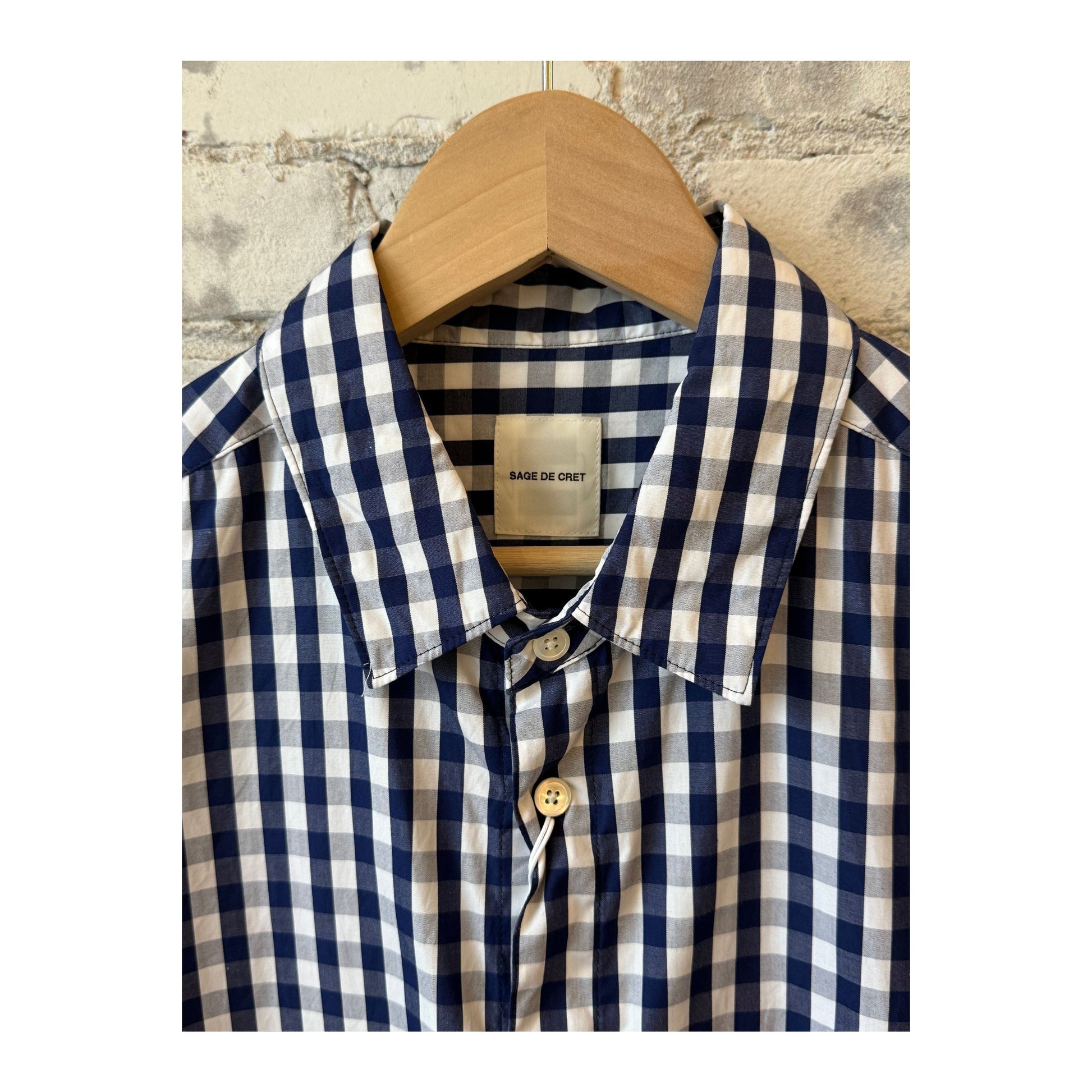 Men's navy gingham check shirt with regular collar by Sage De Cret, showing the classic pattern and tailored fit.