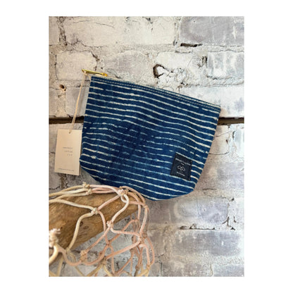 Immodest Cotton sardine pouch in indigo stripe fabric, compact accessories holder with a vibrant, woven pattern.