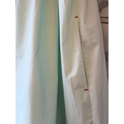 Women's mint scallop dress by Brazeau Tricot, featuring a fitted bodice and scalloped hem, styled on a model.