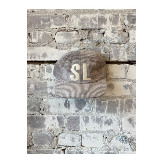 Assorted colors SL Patch Letterman Floppy Cord Hat by Local Supply Club, casual accessory with a soft, floppy brim and letter patches.