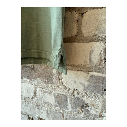 Men's faded green cotton jersey polo shirt by Hartford Men's, showing a close-up of the fabric and collar detail.