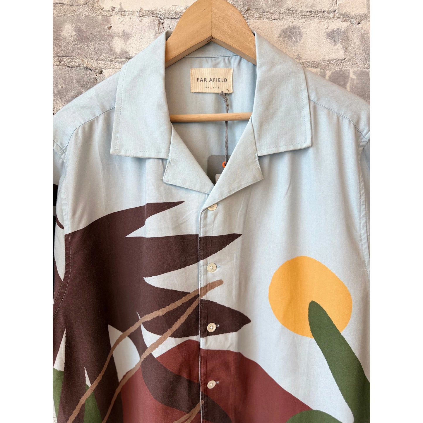 Men's Staccio Shirt by Far Afield featuring a vibrant beach landscape print, lightweight fabric, and casual fit.
