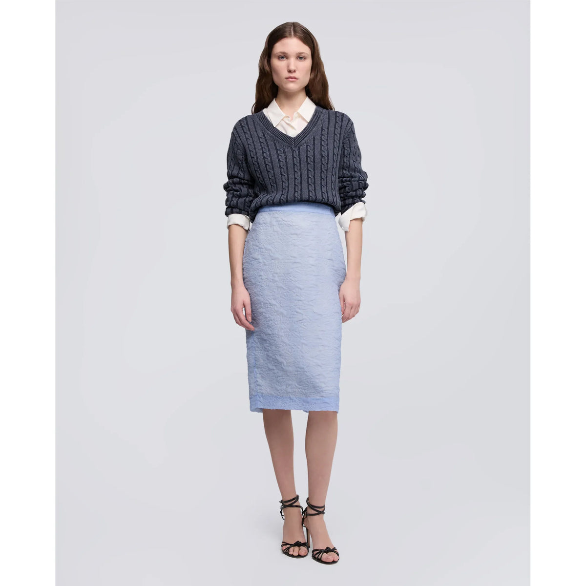 Women's blue stone-washed cotton cable-knit sweater by Aspesi, showing the textured knit pattern and relaxed fit.