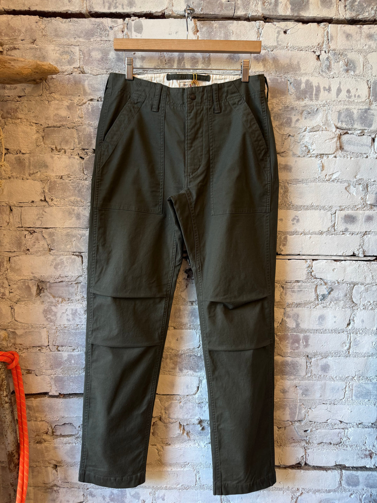 Men's dark smoke Supply Pant by Relwen, featuring a tailored fit and durable fabric, shown in a casual wear setting.