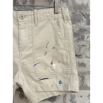 Women's Surplus Short Shorts with paint splatter design in canvas fabric by G1 Women's, shown on a model.
