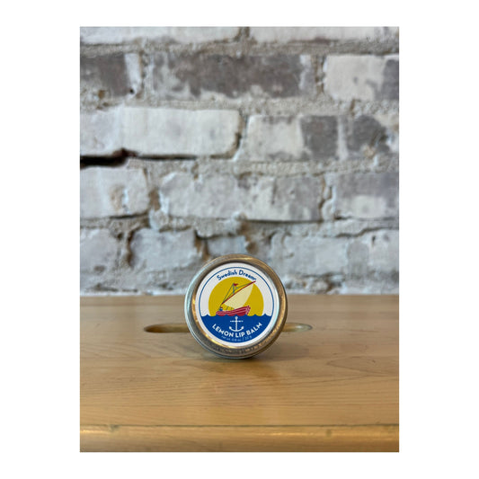 Swedish Dream Lemon Lip Balm by Kalastyle Soap Co. in a sleek accessory container with fresh lemon scent.