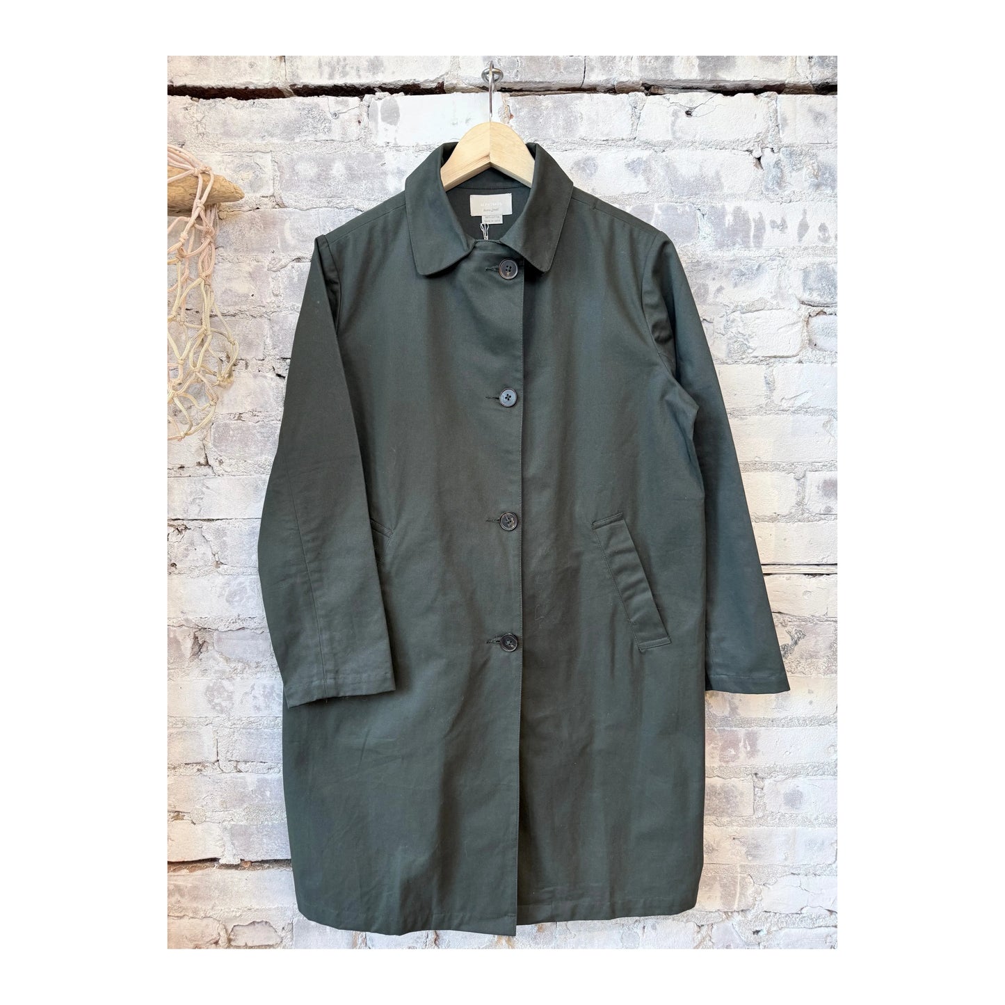 Women’s Sylvie MacKintosh by M.Patmos in forest green, showcasing a stylish, waterproof raincoat with a hood and button details.