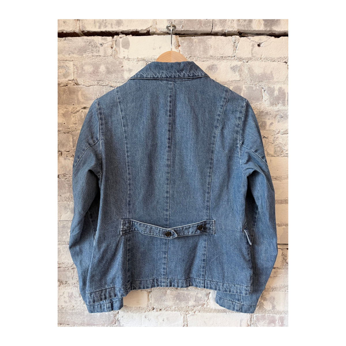 Women's faded blue denim blazer by Pas De Calais, tailored fit with classic lapel and button closure, styled on a mannequin.