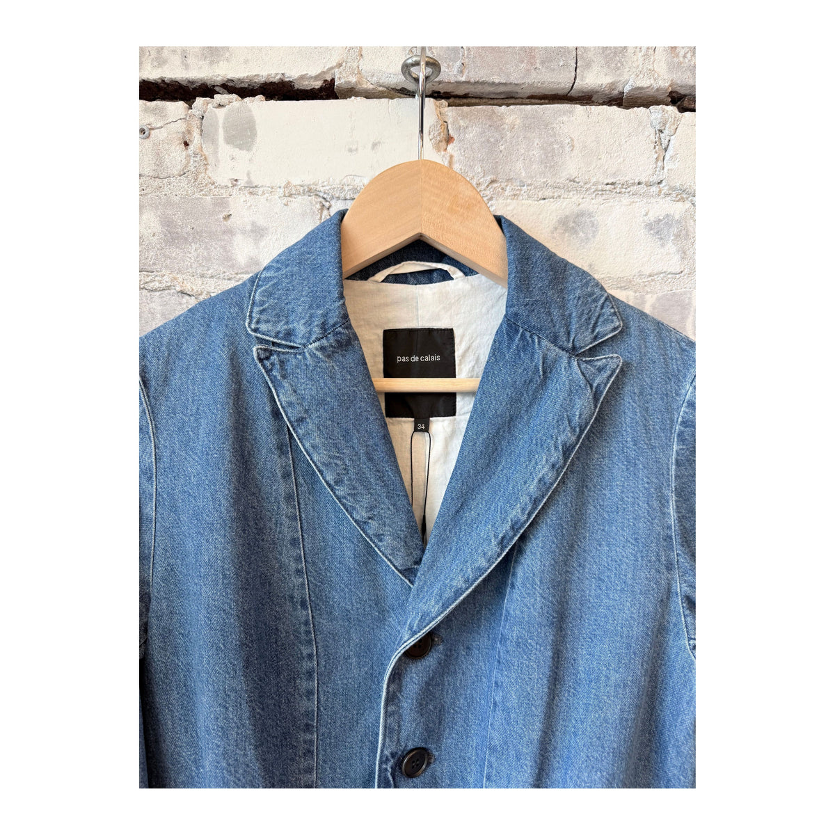 Women's tailored denim blazer in faded blue by Pas De Calais, featuring a fitted style and classic denim texture.