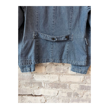Women's faded blue tailored denim blazer by Pas De Calais, shown flat with front buttons and classic collar detail.