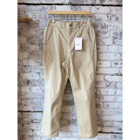 Men's tapered chino cloth pant in beige by Sage De Cret, showcasing a slim fit and classic style on a neutral background.