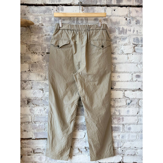 Men's Sage De Cret tapered crinkle typewriter easy pants in tan, showing the relaxed fit and textured fabric.