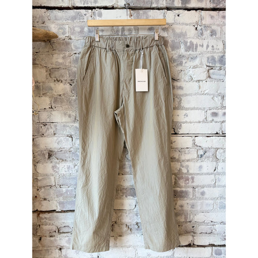 Men's Sage De Cret tapered crinkle typewriter easy pants in tan, featuring a relaxed fit and lightweight, textured fabric.
