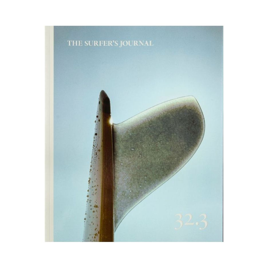 The Surfer's Journal 32 editions displayed in a neat stack, showcasing the magazine covers and surf-inspired artwork.