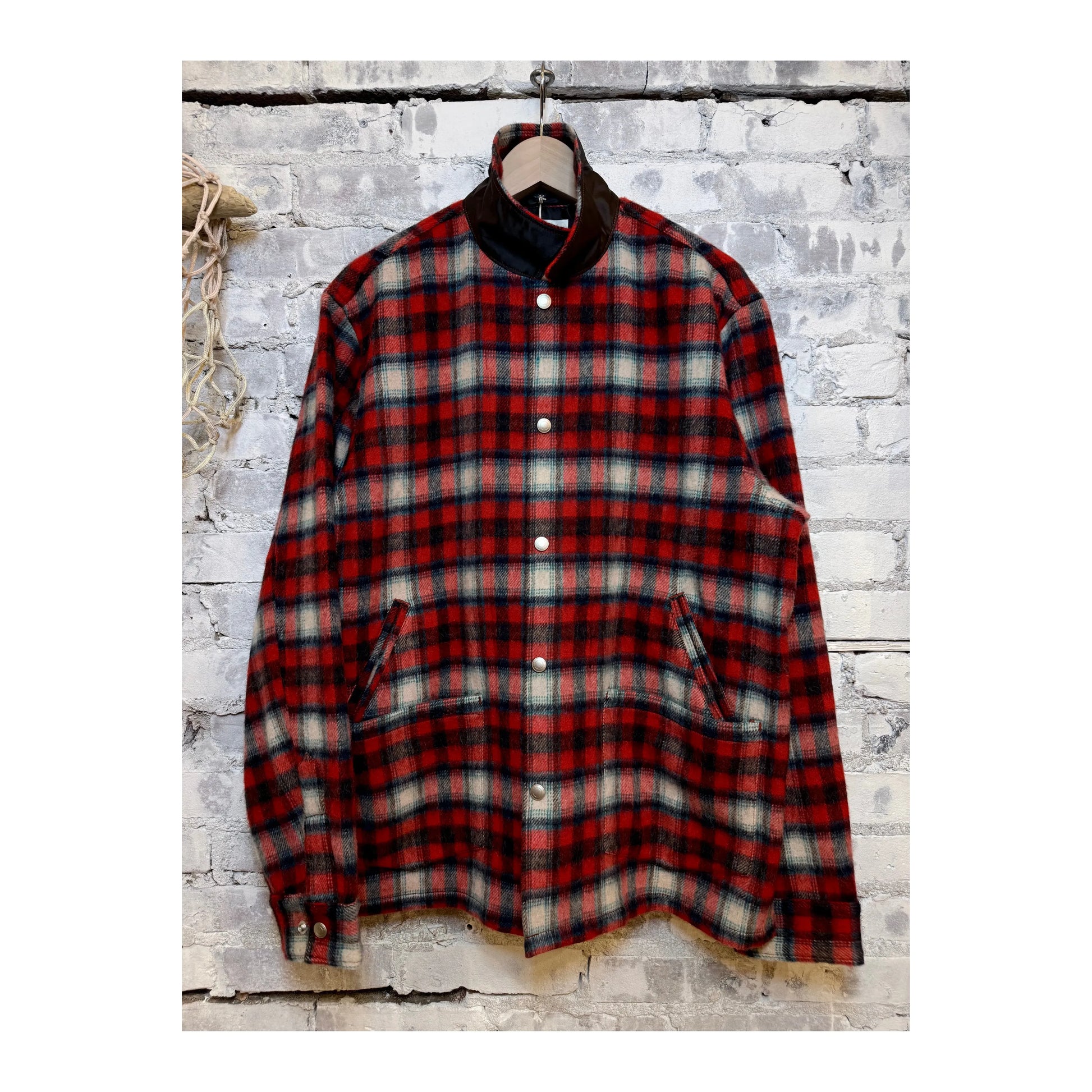 Men's Fujito "Tom" CPO jacket in red check pattern, featuring button closure and classic collar, displayed on a hanger.