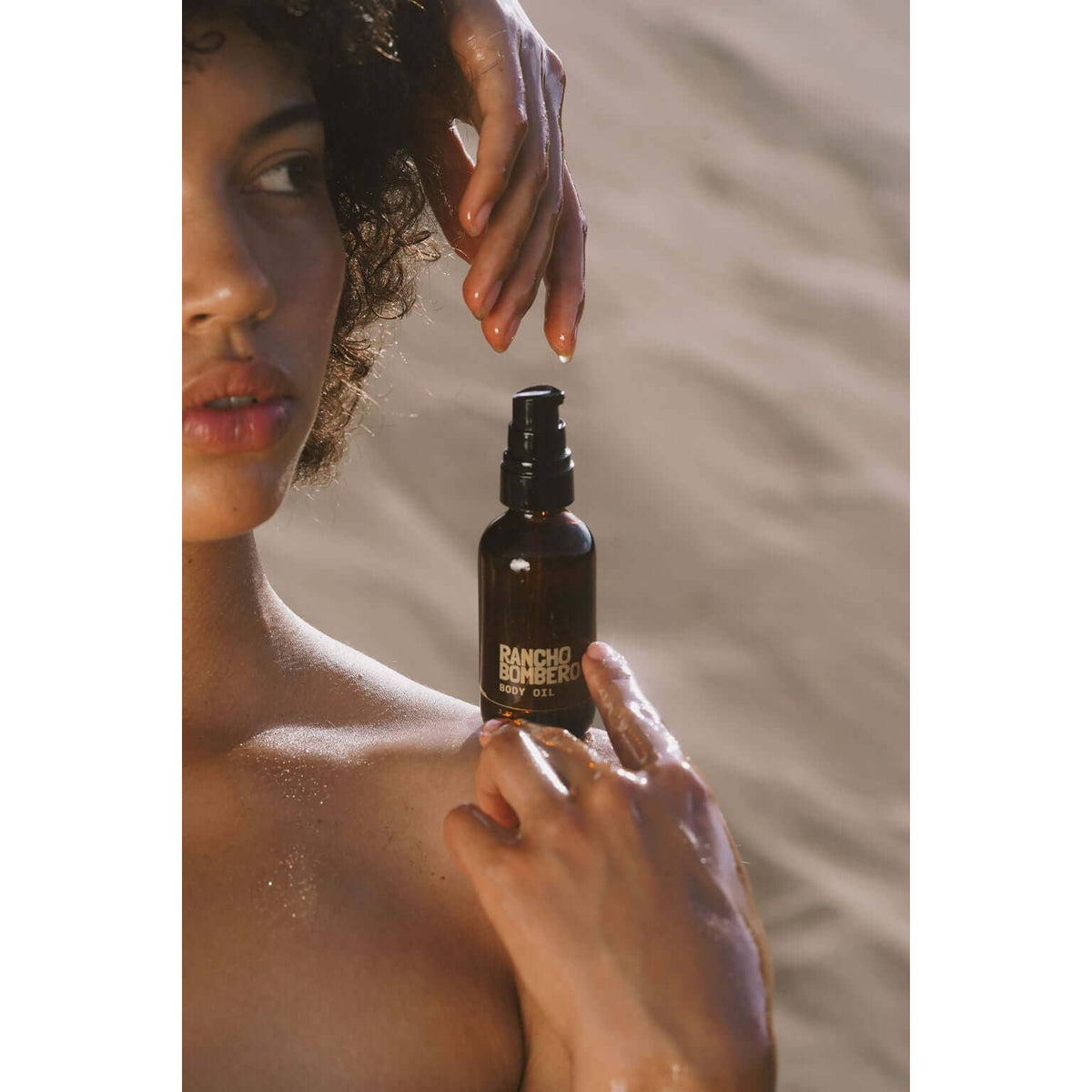 Rancho Bombero Total Body Oil in 2 oz. bottle, featuring a sleek accessory container, designed for nourishing skin.