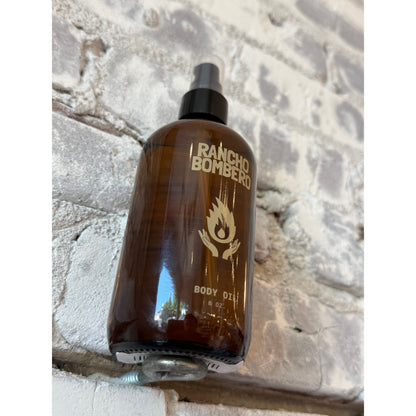 Rancho Bombero total body oil in an 8 oz. bottle, showcasing the sleek packaging and smooth, nourishing oil inside.