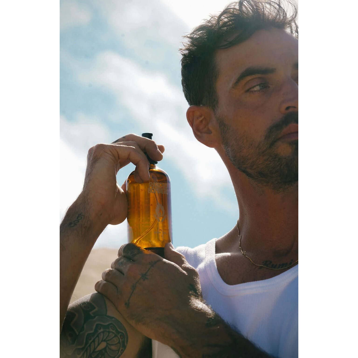 Rancho Bombero Total Body Oil 8 oz. in a clear glass bottle with a pump dispenser, shown as an accessory product.