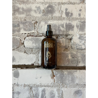 Rancho Bombero Total Body Oil 8 oz. bottle, natural skincare accessory with a sleek design and label, for nourishing skin.