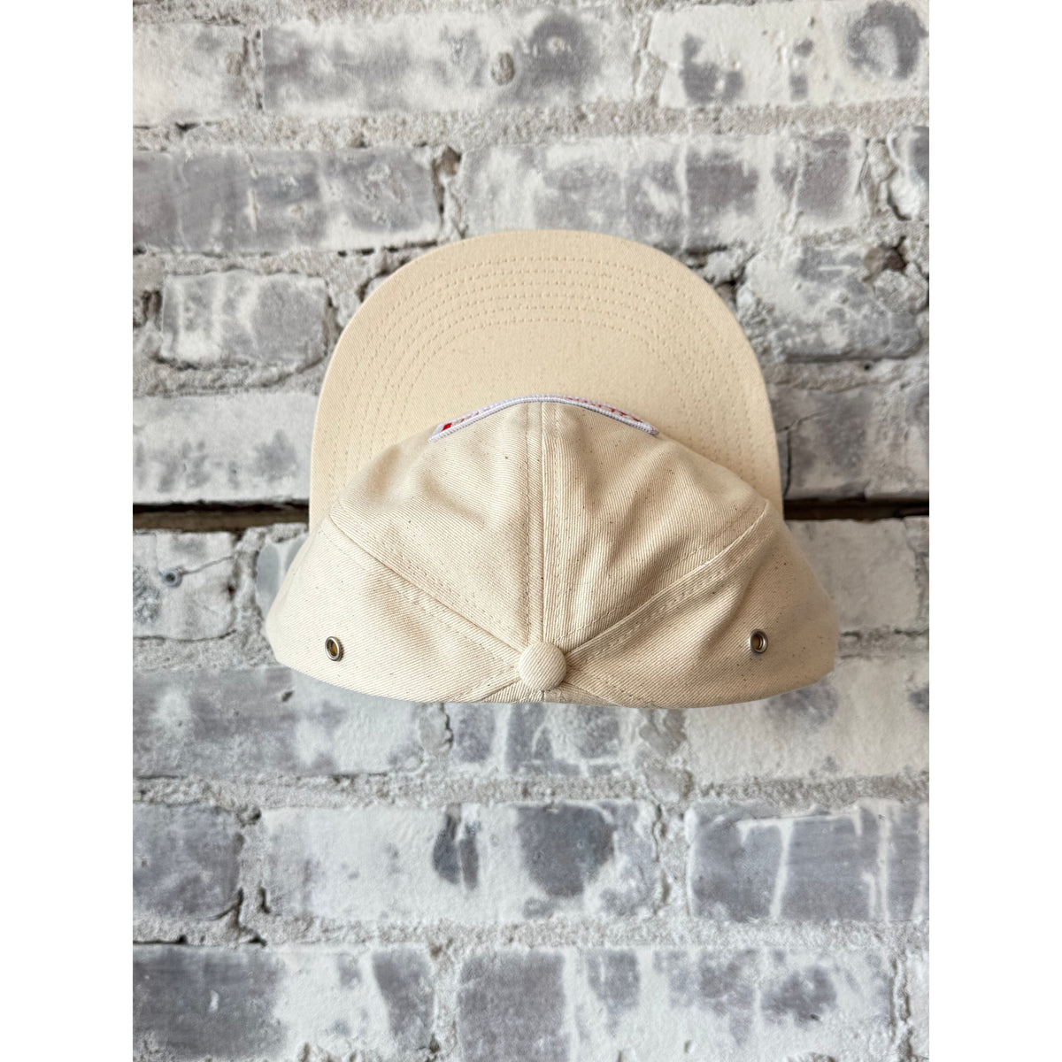 Men's Truckin' Twill Hat in Vanilla Bean by Big Rock Candy Mountaineering, shown in a close-up view of the hat's fabric and design.