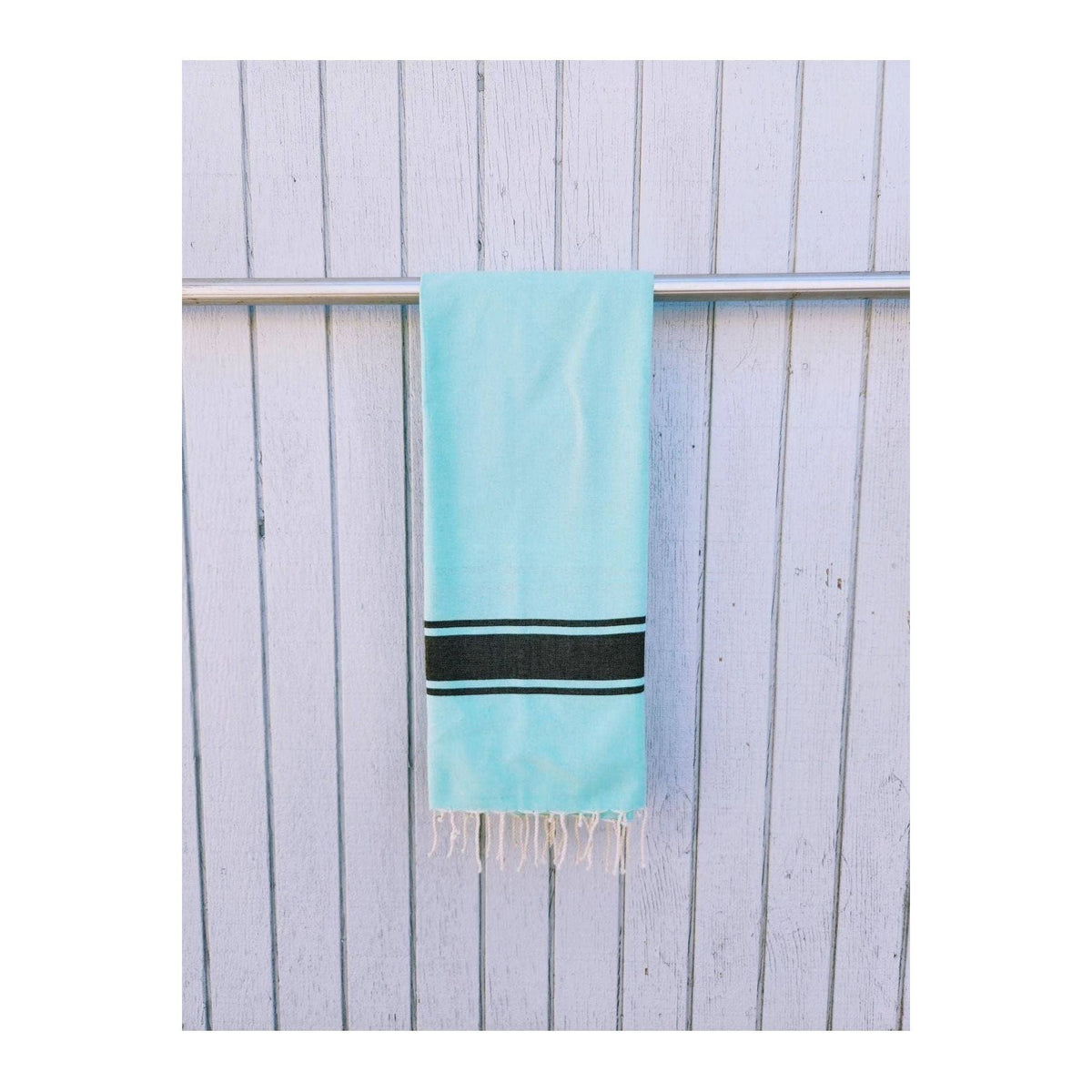 Wonderfouta Turkish beach towel sarong in aqua and black, featuring vibrant patterns perfect for beach or poolside accessories.