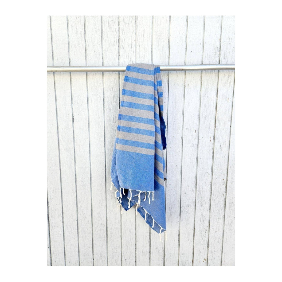 Wonderfouta Turkish beach towel sarong in Blue Stone, featuring vibrant blue and stone patterns, perfect for beach or poolside use.