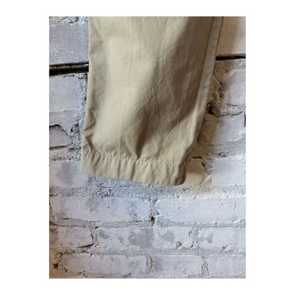 Men's khaki twill chino pants by Save Khaki United, showing the classic fit and fabric texture in a natural pose.