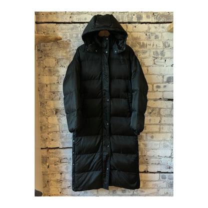 Women's long puffer jacket by TWIN in black and royal blue, featuring a warm, quilted design with a high collar.
