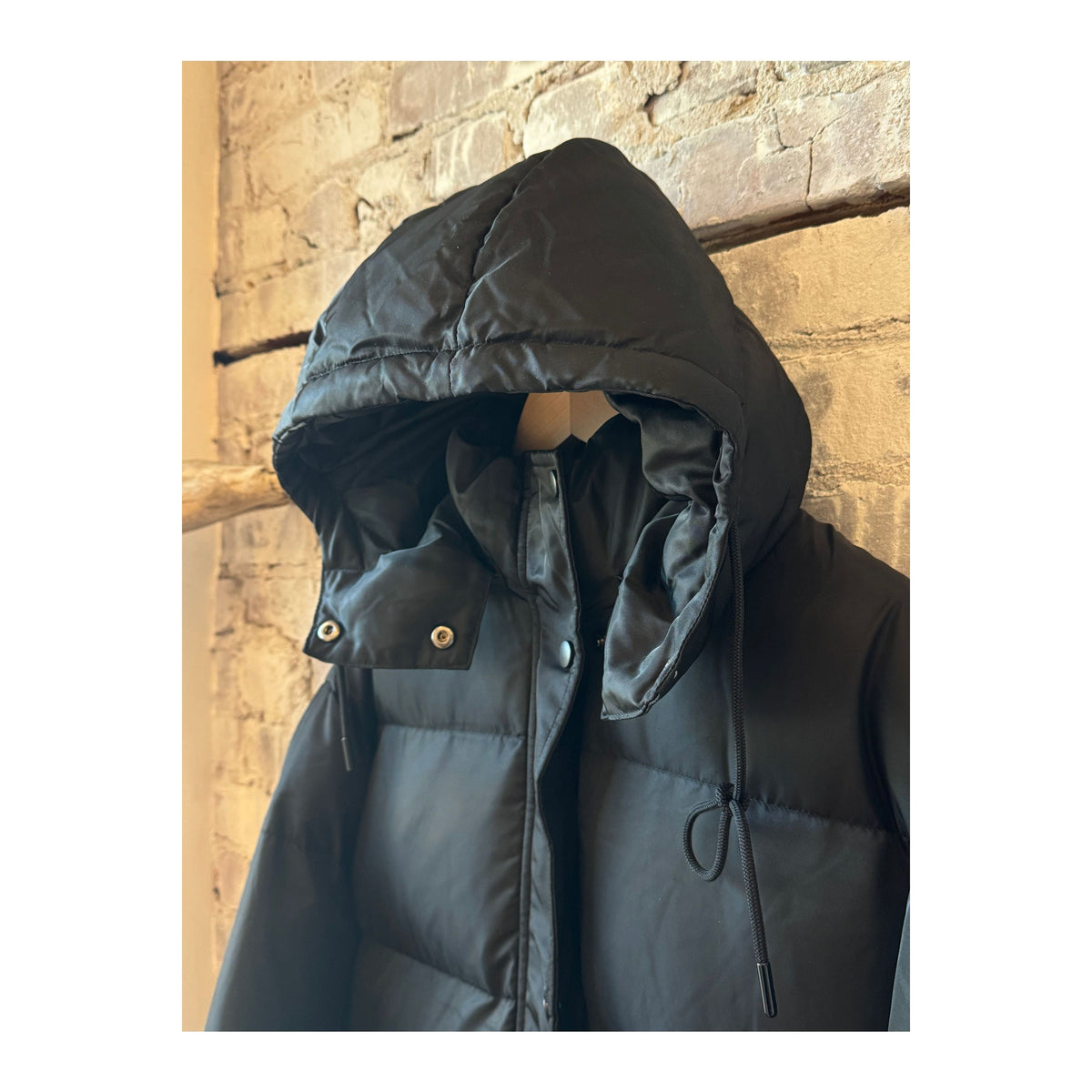 Women's long puffer jacket by TWIN in black and royal blue, featuring a stylish, insulated design for cold weather.