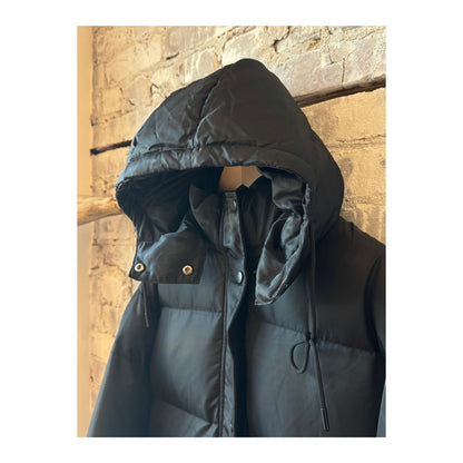 Women's long puffer jacket by TWIN in black and royal blue, featuring a stylish, insulated design for cold weather.