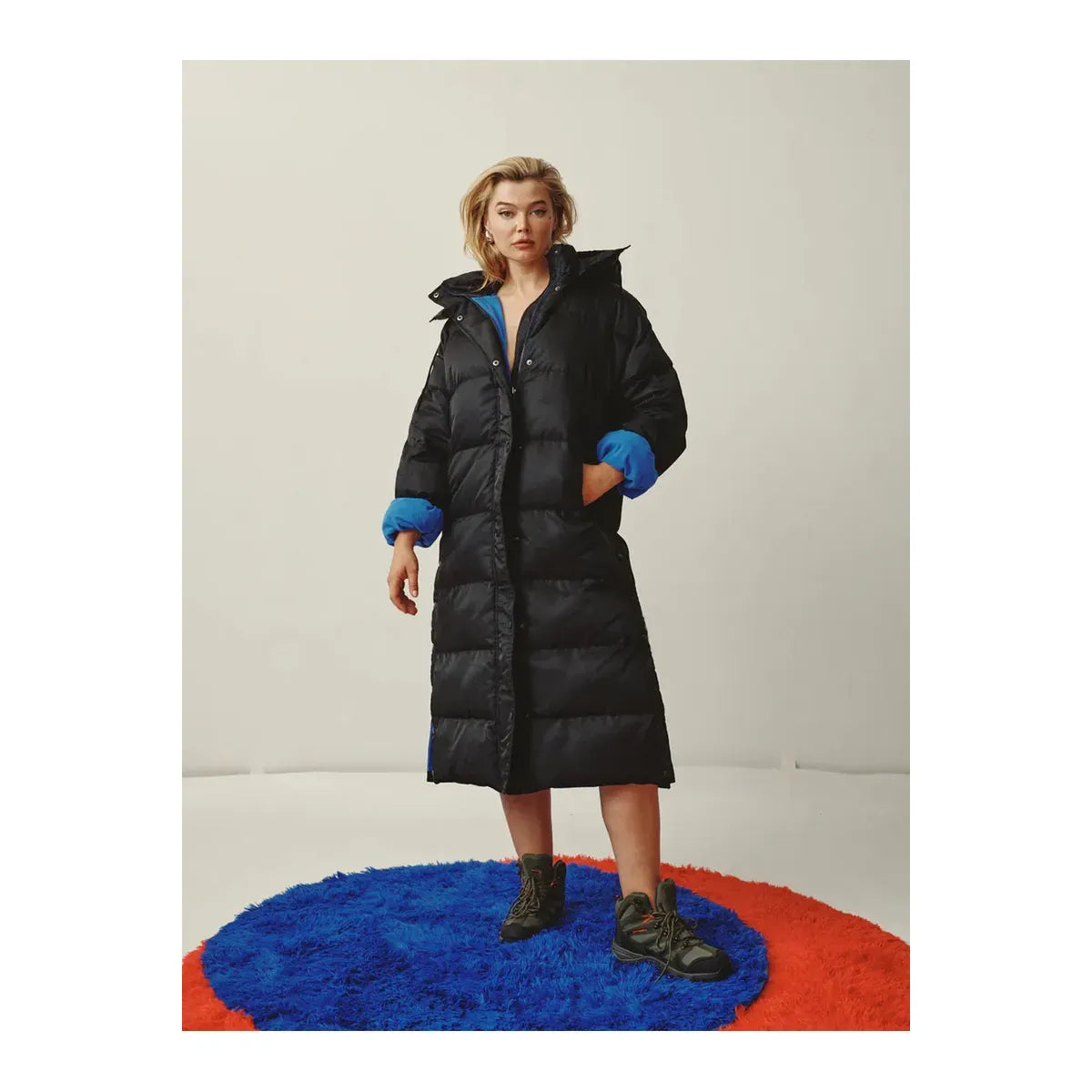Women's long puffer jacket by TWIN in military orange, featuring a quilted design and insulated for warmth.