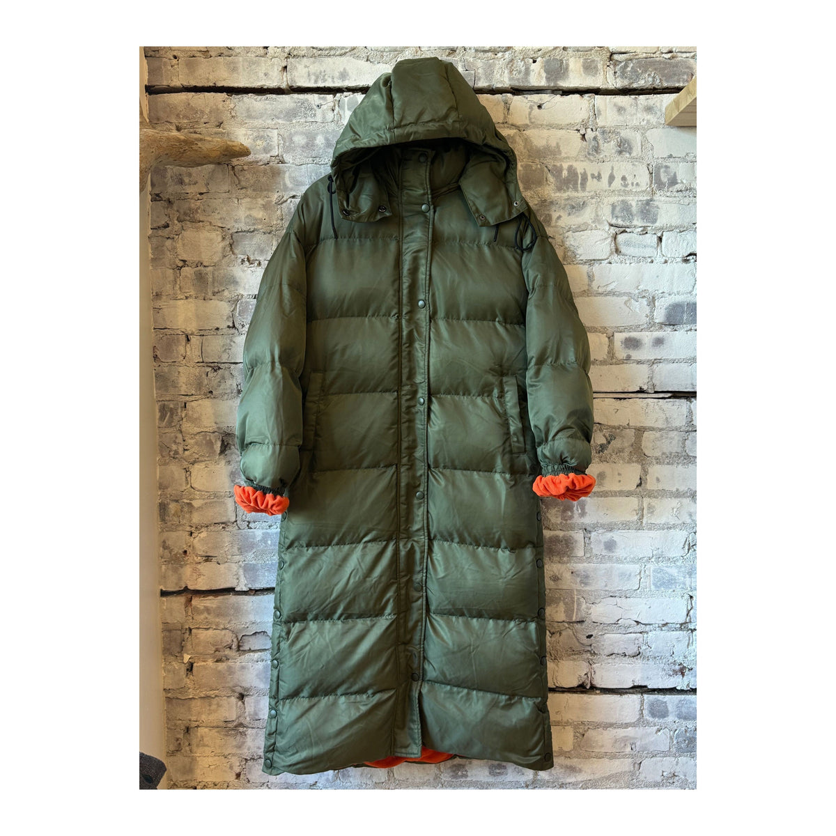 Women's TWIN 06 Long Puffer jacket in military and orange color, with a quilted design and high collar for warmth.
