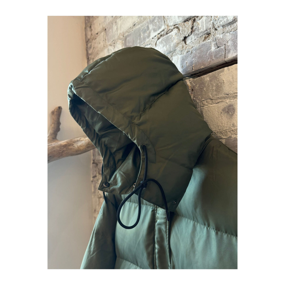 Women's orange long puffer jacket by TWIN, military-inspired design with a padded, insulated look and a hood.