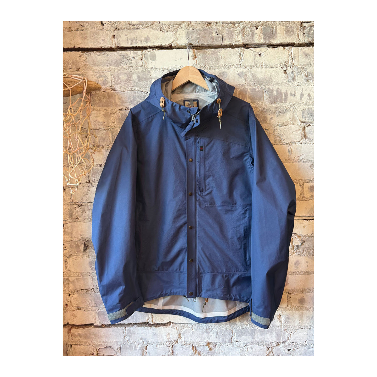 Men's Ultra Rain Shell in Bright Navy by Relwen, lightweight waterproof jacket with a hood and adjustable cuffs.