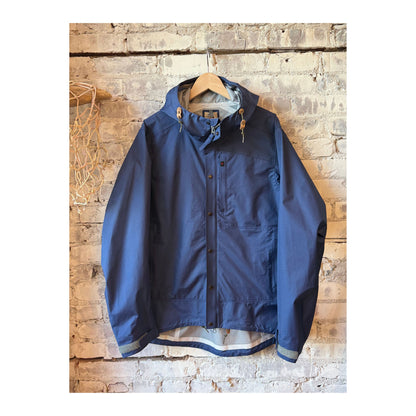Men's Ultra Rain Shell in Bright Navy by Relwen, lightweight waterproof jacket with a hood and adjustable cuffs.