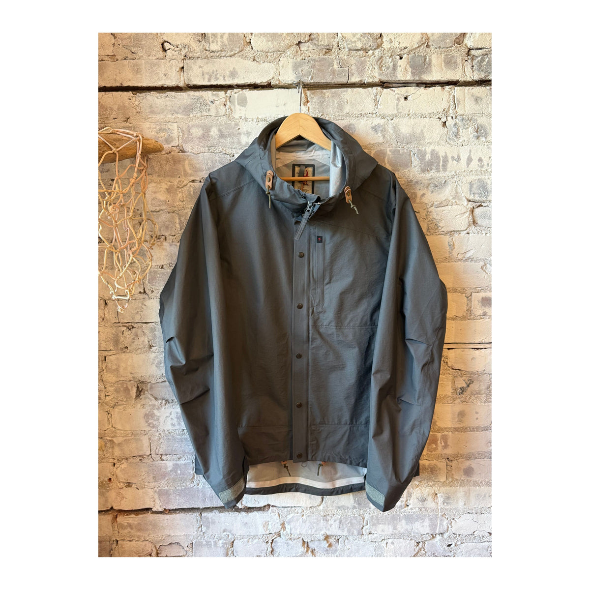 Men's Ultra Rain Shell by Relwen in charcoal, lightweight waterproof jacket with hood and adjustable cuffs, casual outdoor wear.