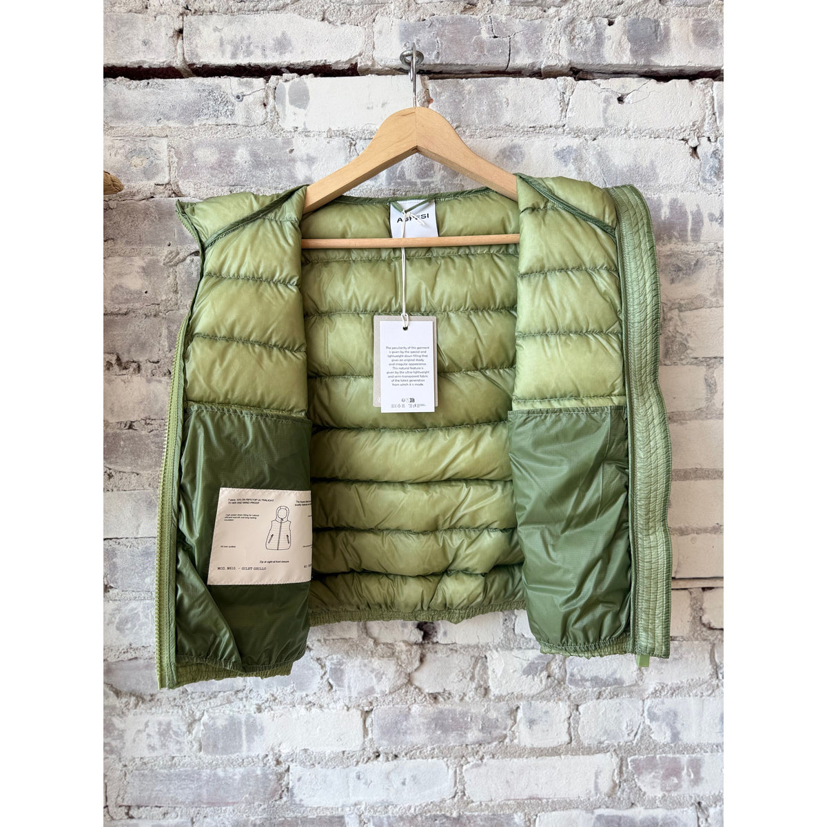 Women's Aspesi ultralight ripstop nylon vest in sage green, showing the lightweight fabric and minimalist design.