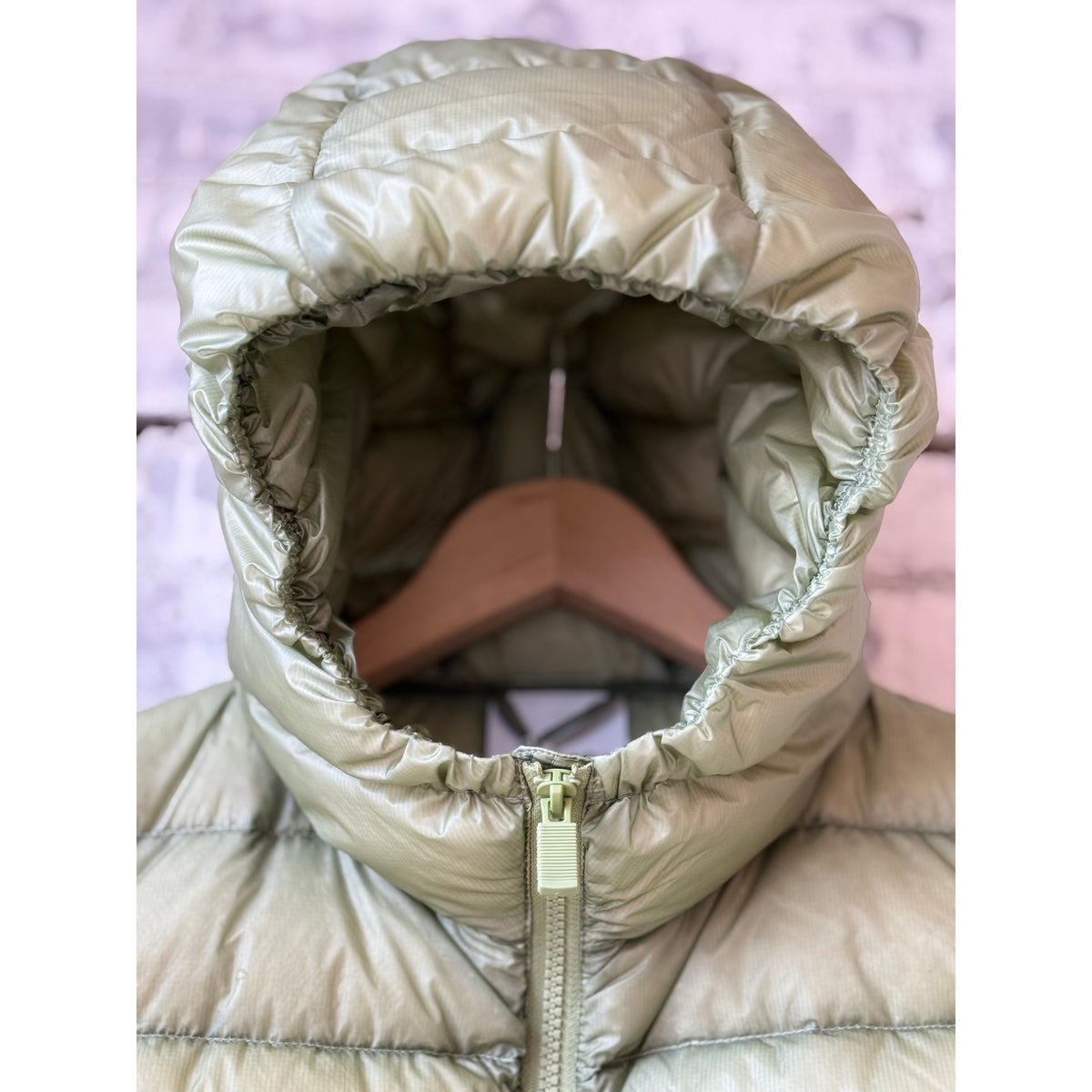 Women's Aspesi ultralight ripstop nylon vest in sage green, showcasing its lightweight fabric and sleek design.
