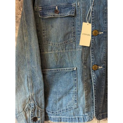 Unisex 11oz selvedge denim chore jacket from Chimala, showing the classic front with button closures and durable fabric.