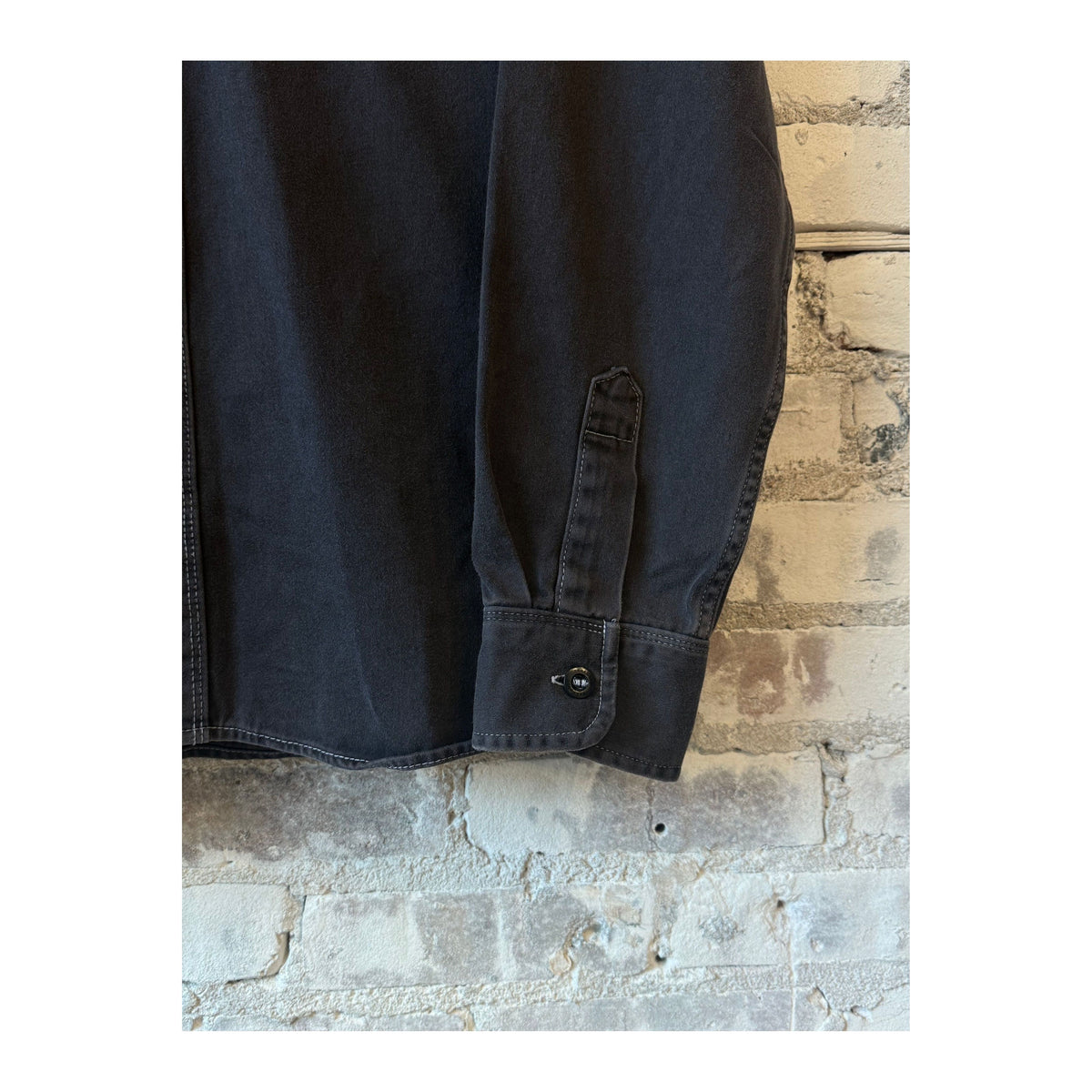 Men's charcoal utility twill shirt by Freenote Cloth, featuring a rugged fabric and casual fit, displayed on a hanger.