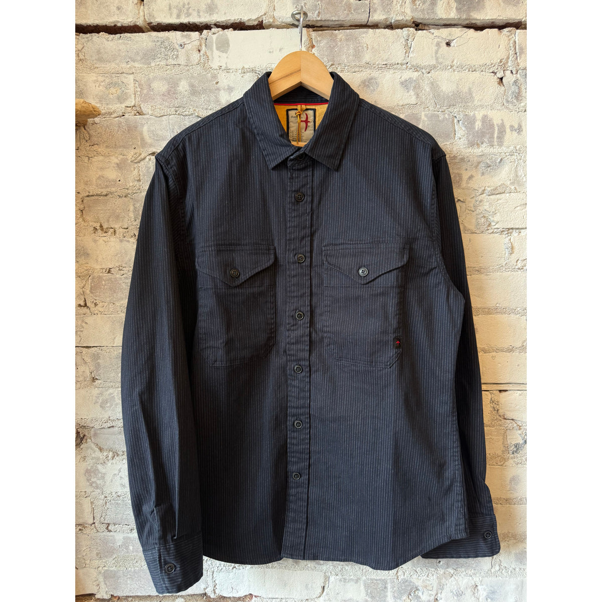 Men's dark navy tick stripe utility workshirt by Relwen, featuring a classic button-up design with long sleeves and chest pockets.