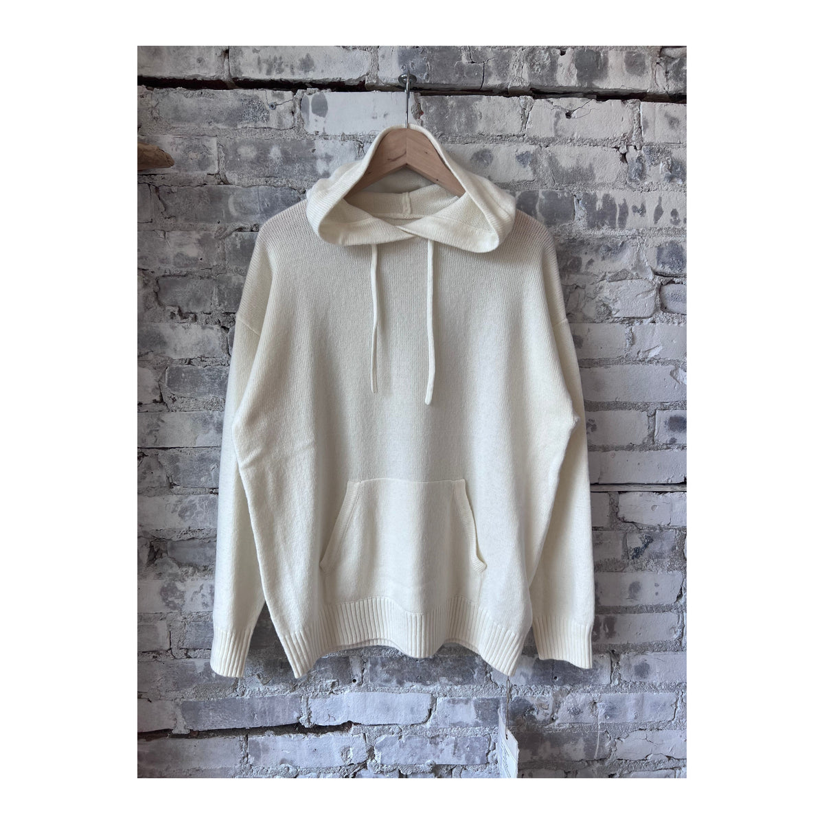 Women's ivory Merino Jersey Knit Loose Hoodie by V::Room, showcasing a cozy, relaxed fit with soft, lightweight merino wool fabric.