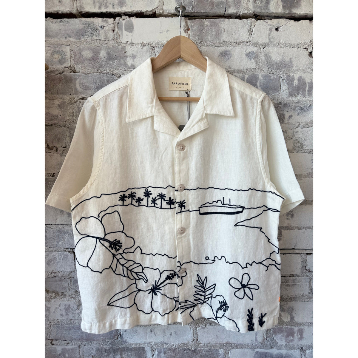 Men's white Veloso Landscape shirt by Far Afield, featuring a detailed landscape pattern, displayed on a hanger.