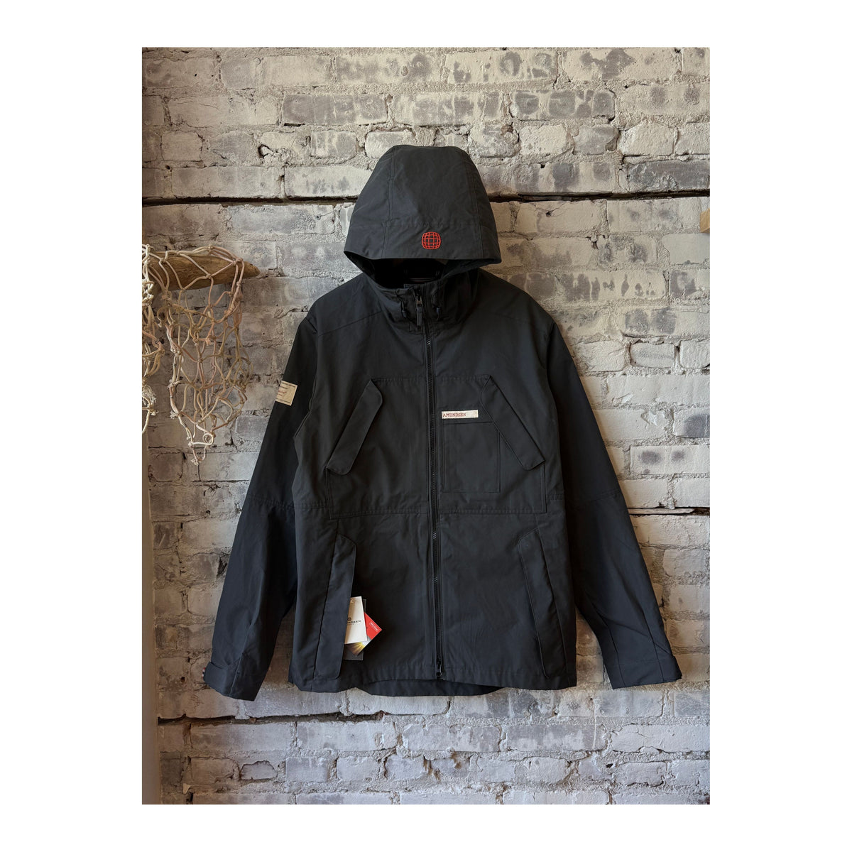 Men's Amundsen Vidda Unisex Jacket in charcoal, showcasing the dark, durable outdoor jacket with a hood and outdoor-ready design.